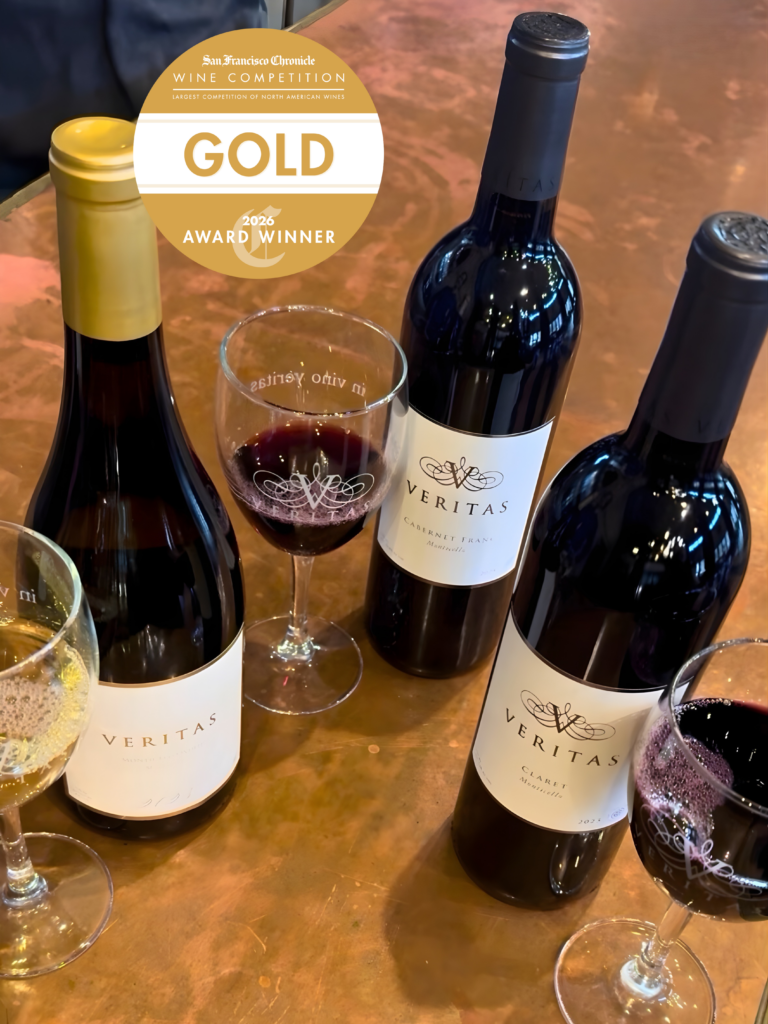 A bottle and glass shot Veritas' San Francisco Chronicle Wine Competition Gold winners, along with the logo.