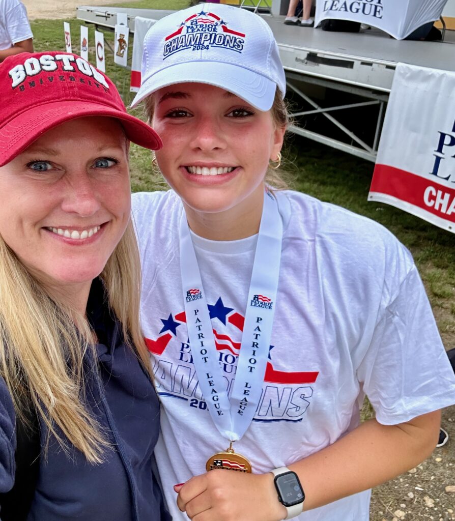 Photo of two women posing for a selfie at a rowing competition.