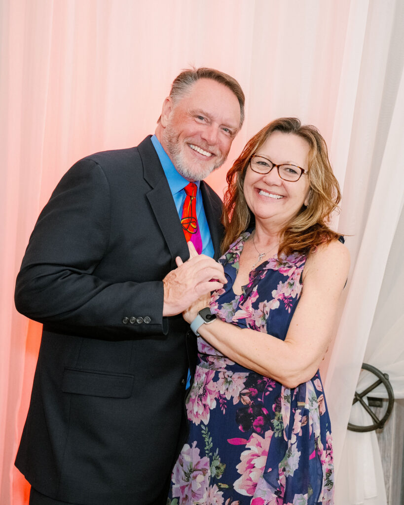 A couple poses for a photo. 