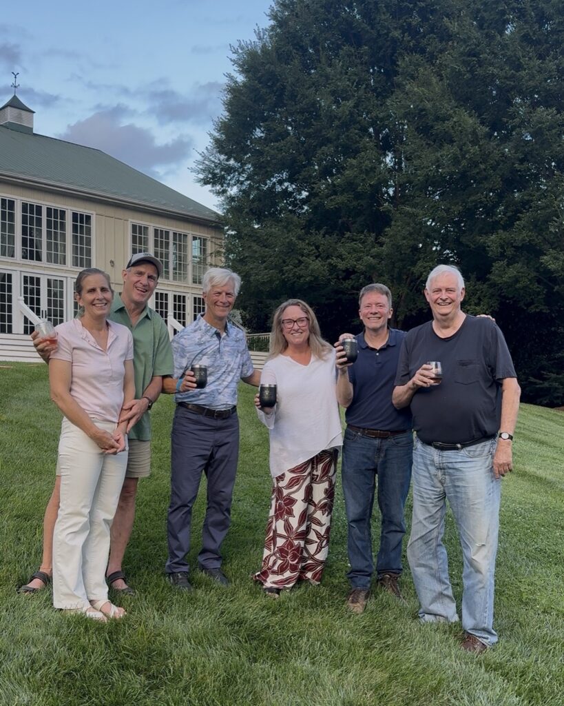 A group of six people stand in front of the ballroom at Veritas Vineyard and Winery.